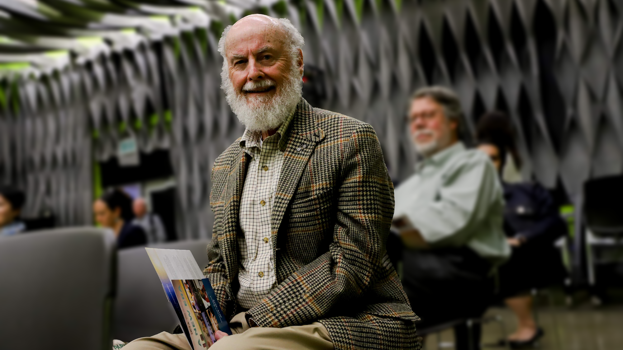 Donald Shoup sits holding papers